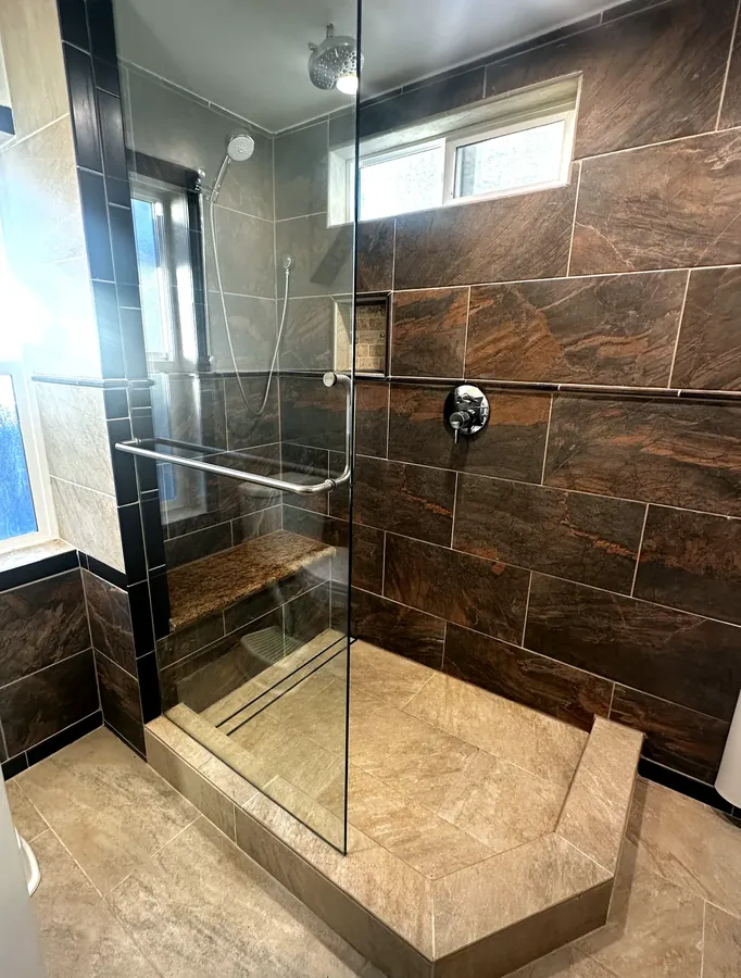 Frameless glass shower door on a walk-in tile shower in the Tri-Cities